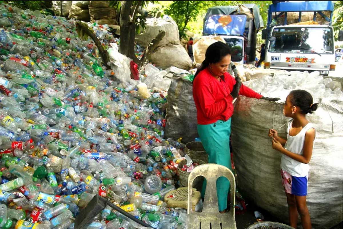 woman and girl sorting plastic recycling in developing country
